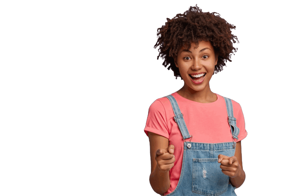 positive young curly woman selects you points with both index fingers camera smiles happily wears casual clothes being glad satisfied stands against purple background you are my type